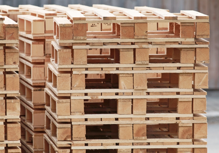 Pile of standard wooden pallets on a storage area